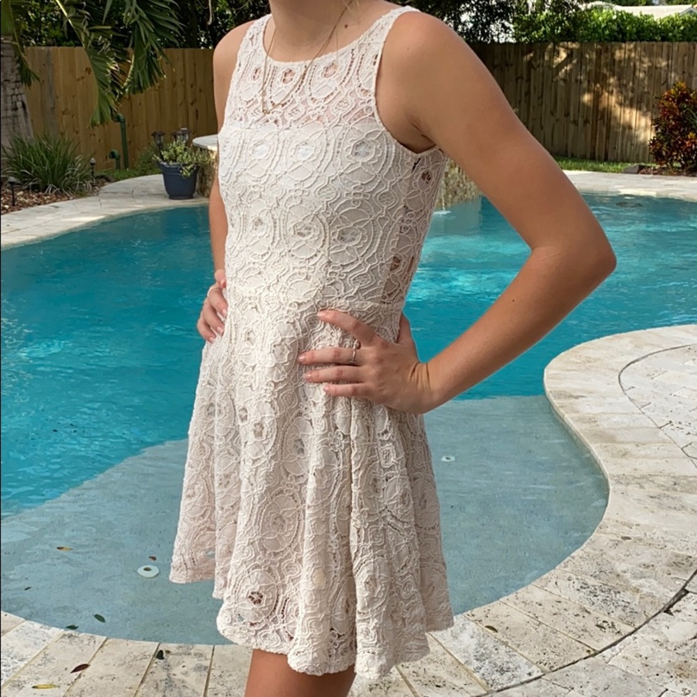 Off white lace mini dress with zipper in the back.